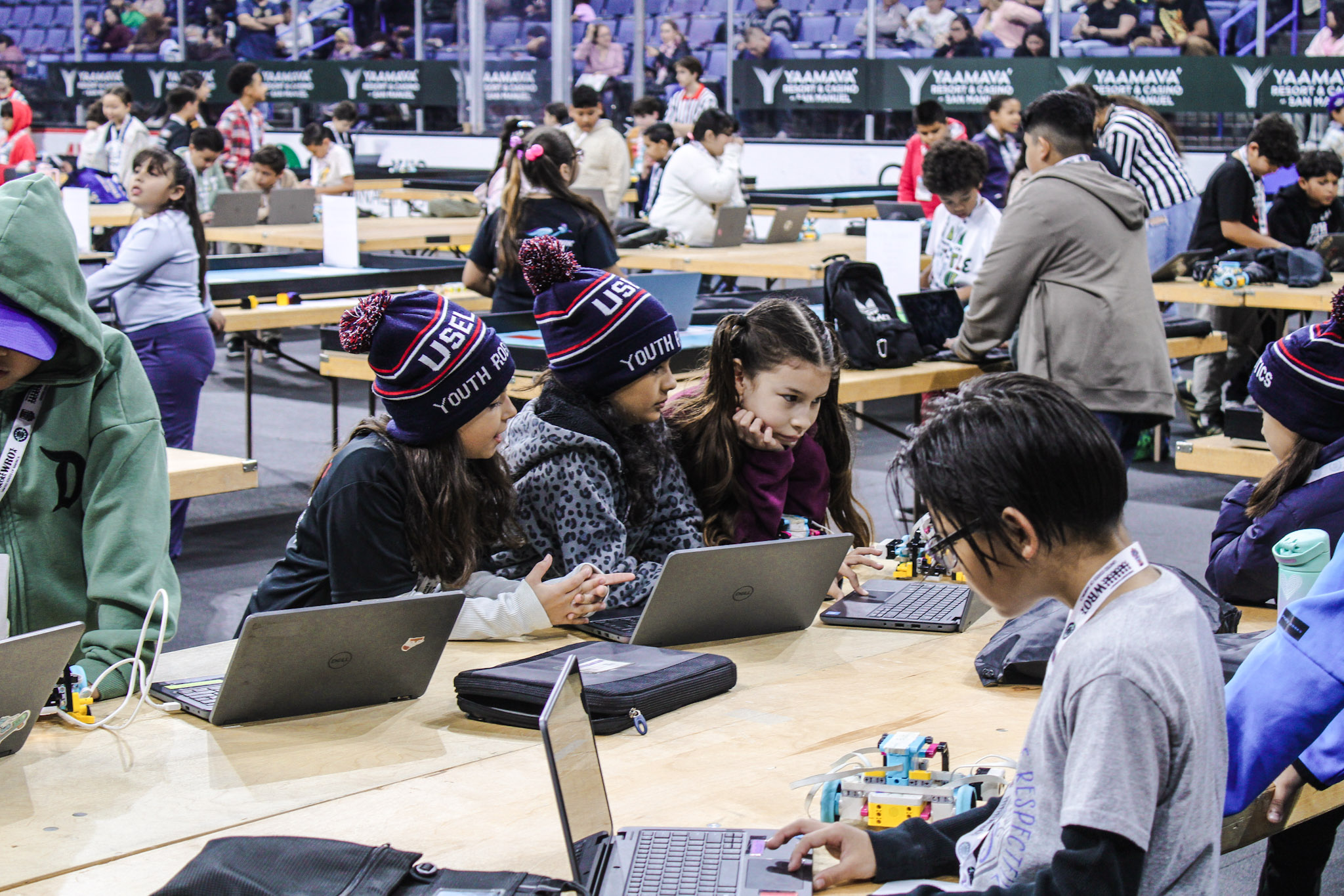 Students coding at table