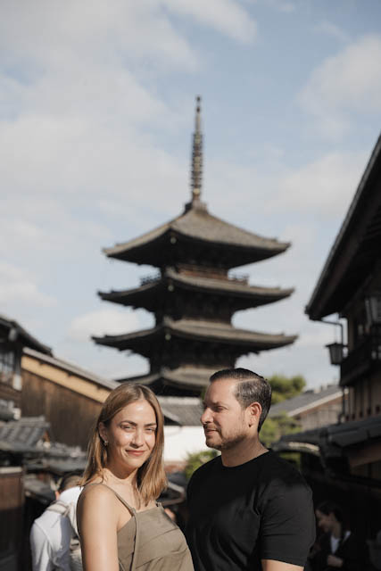 Couple standing in front of traditional Japanese pagoda