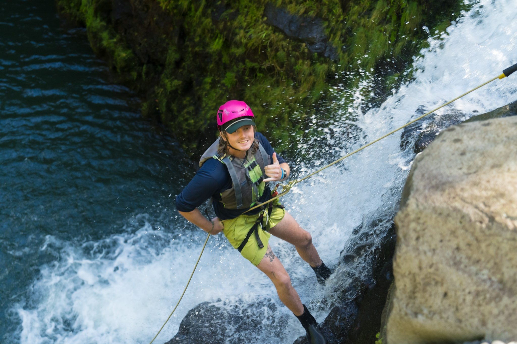 Rappel Maui rappeller giving the Hawaiian shaka sign of hang loose