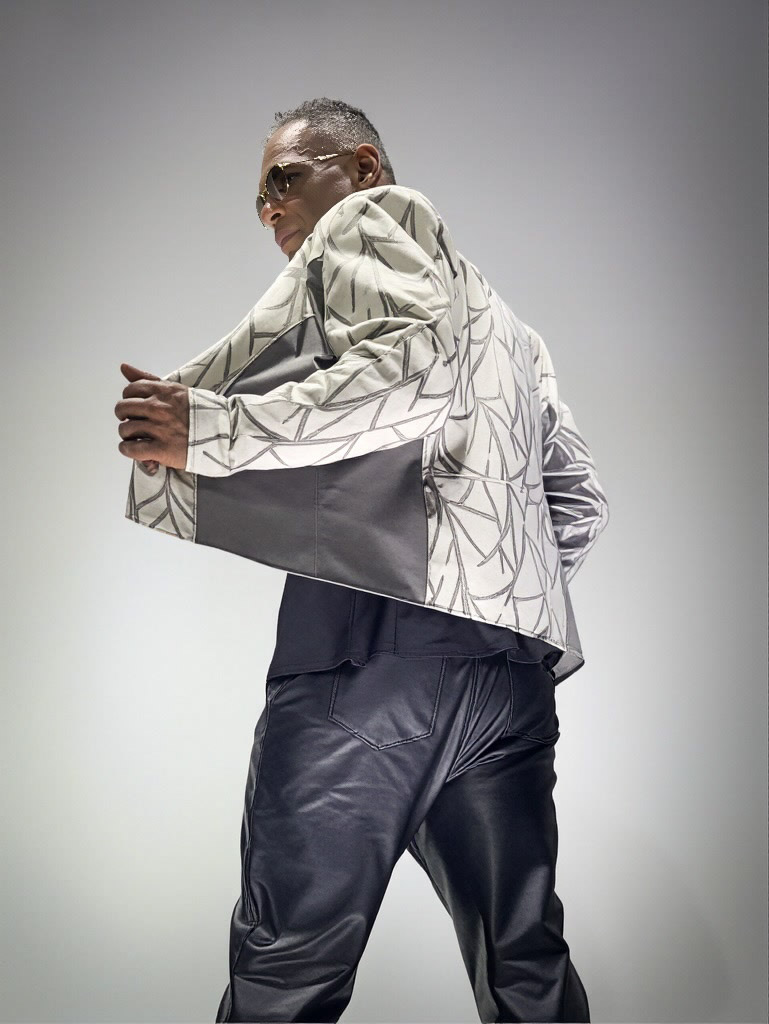Kristopher wearing a silver patterned blazer.
