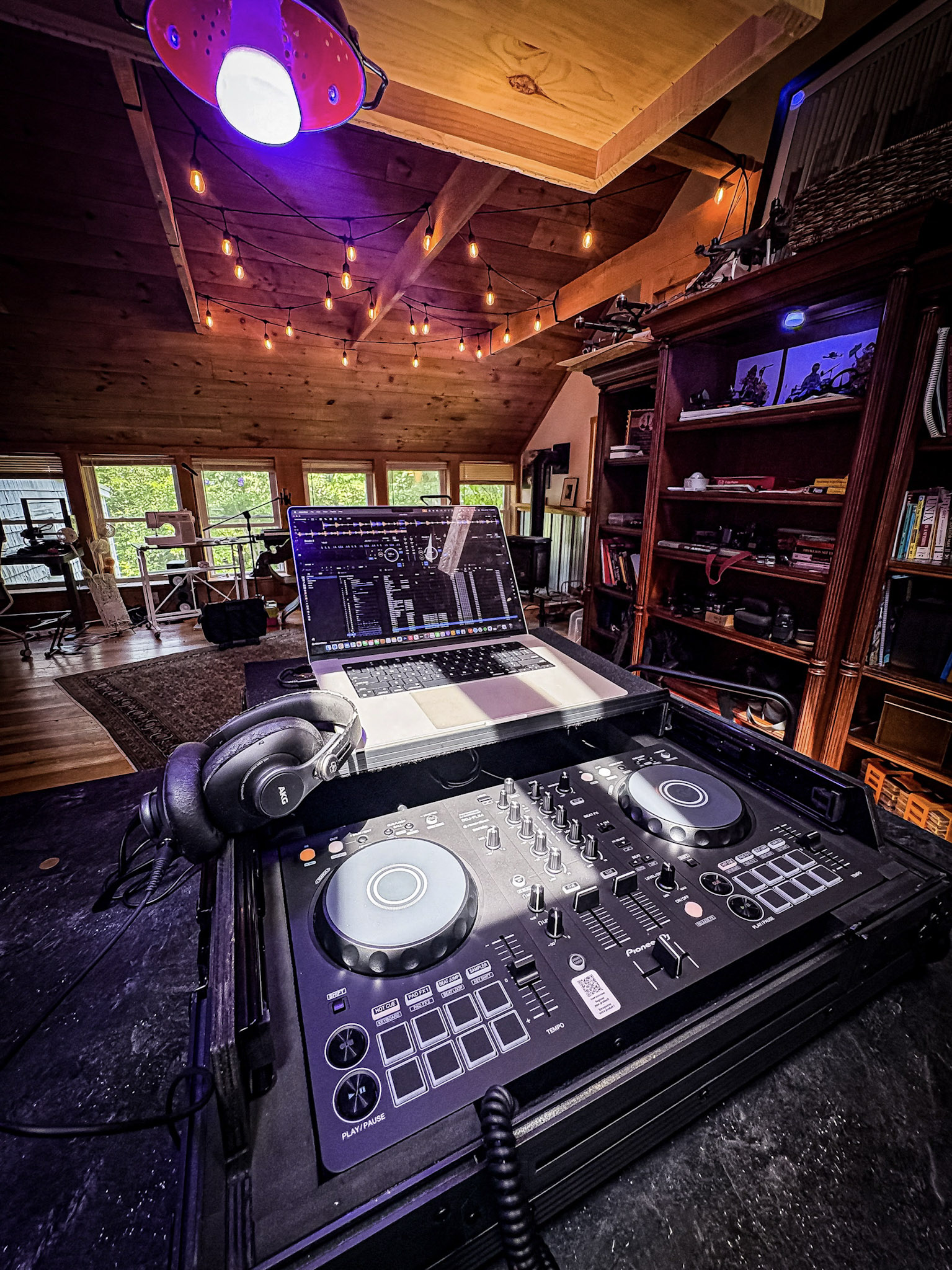 DJ controller and laptop in creative room.