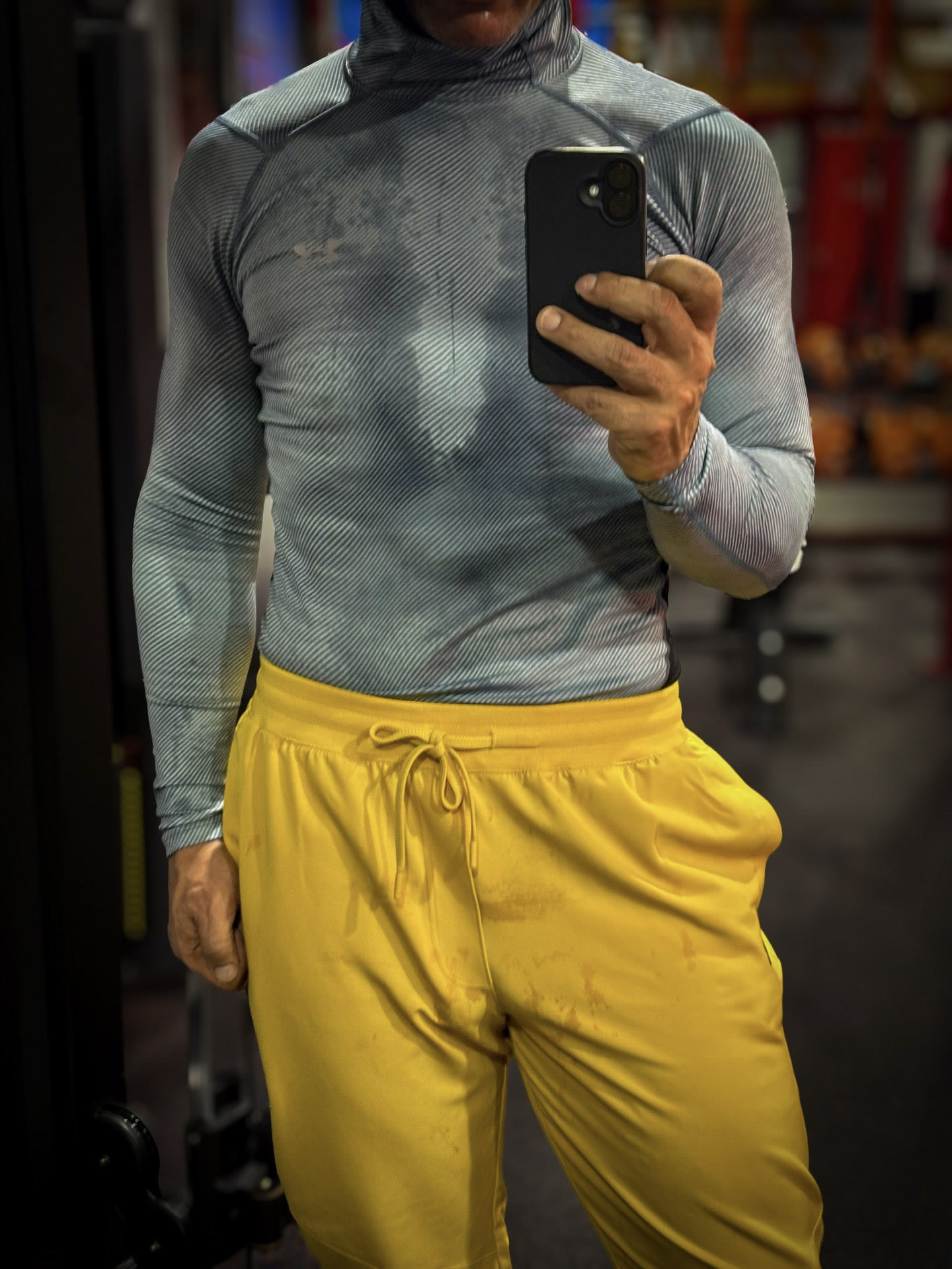 Gray/yellow mirror portrait; sampled clips show mat movement and an exercise bike.