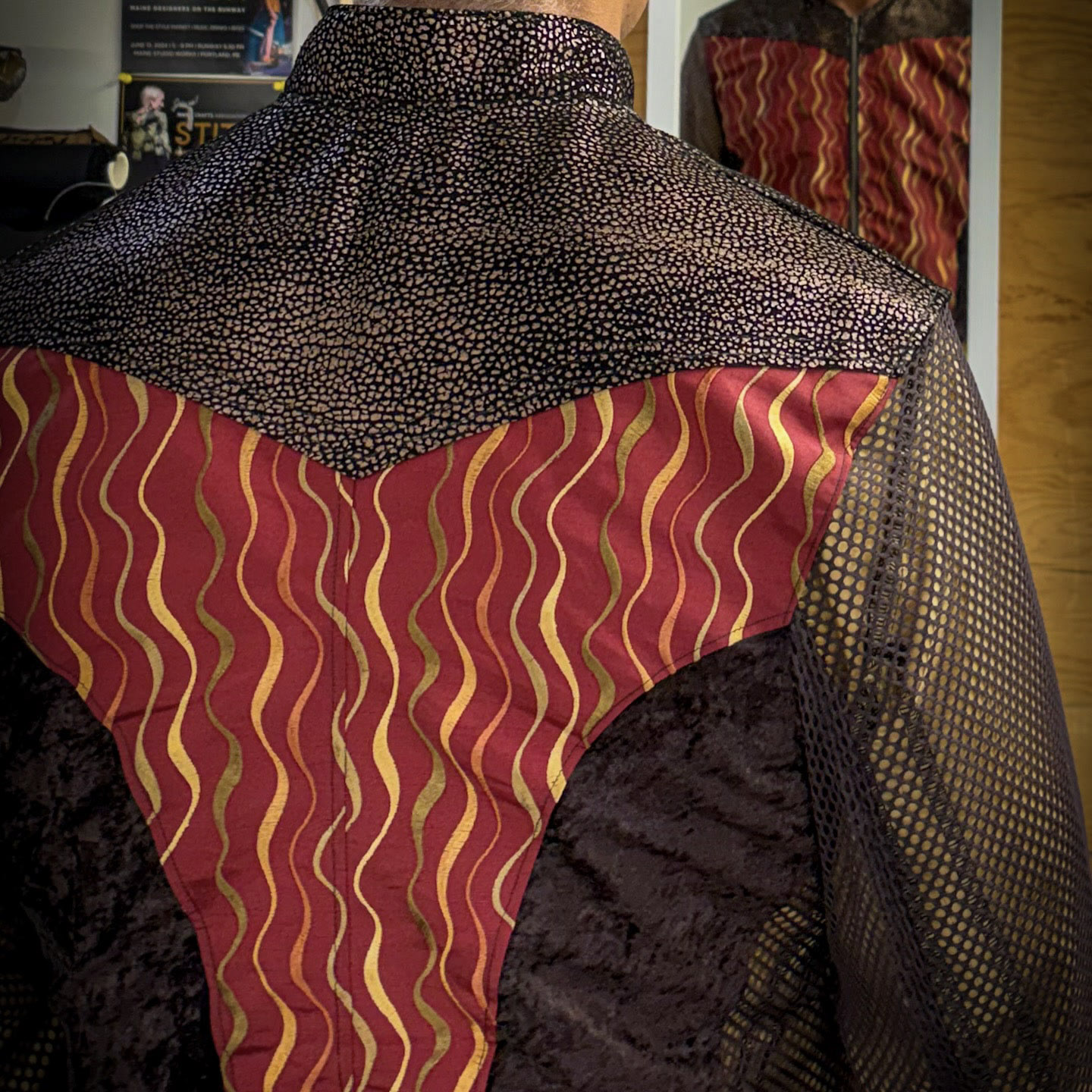 Patterned garment textures and contrasting fabric panels.