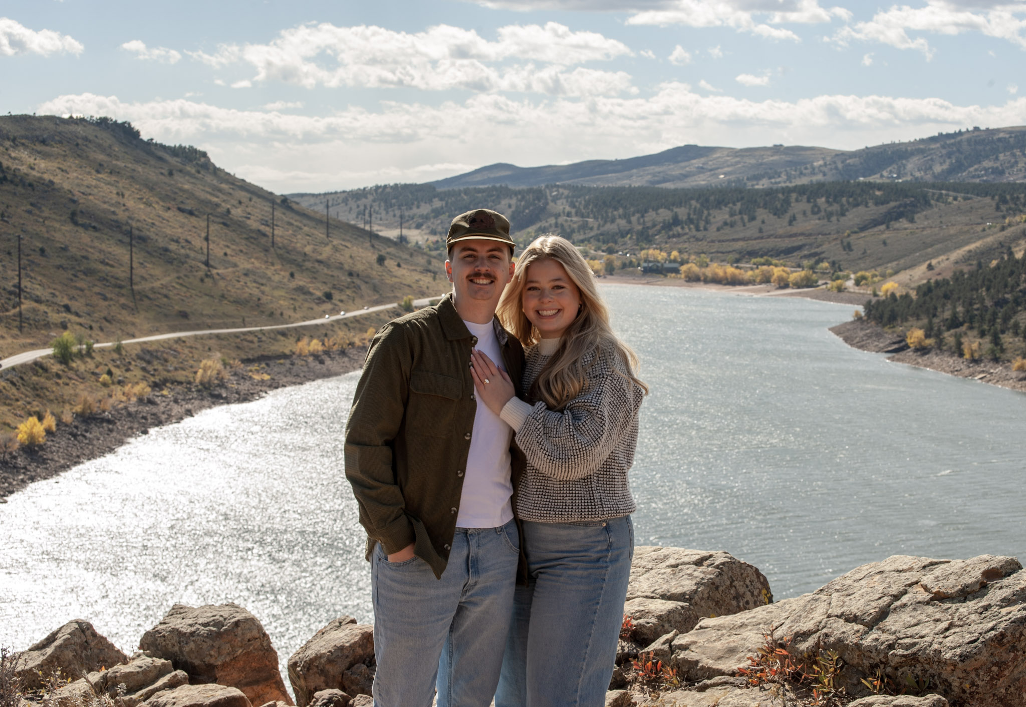 A couple holding hands outdoors at golden hour